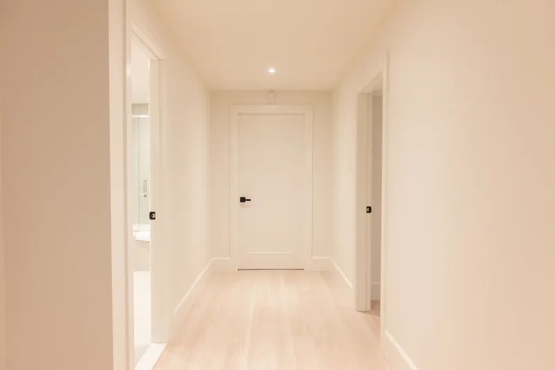 Bright hallway with white oak floors and panel doors