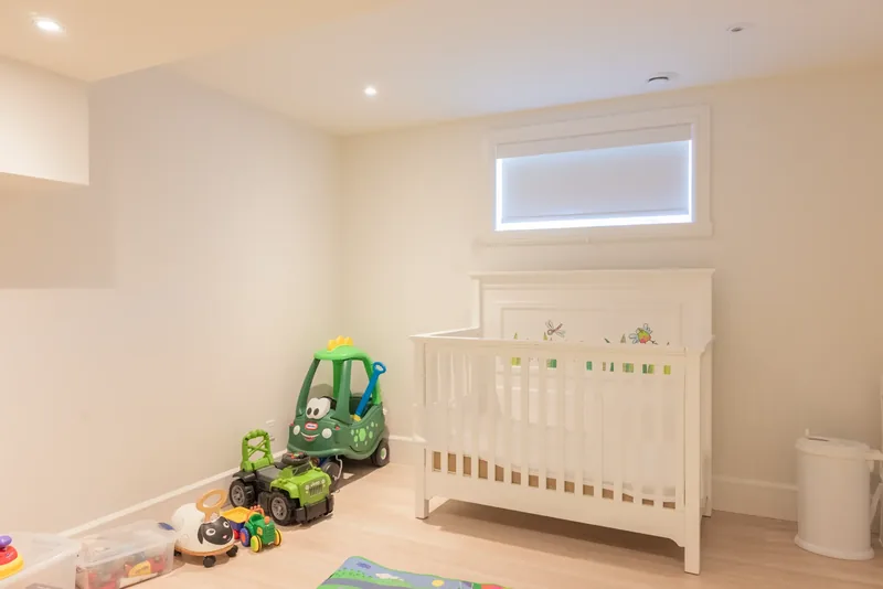 Nursery with a white crib and toys