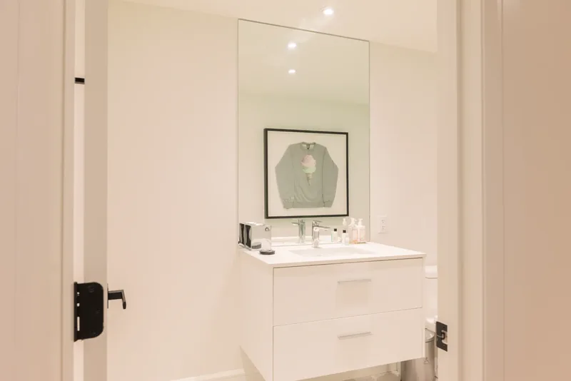 Powder room with a floating vanity and a wall mirror